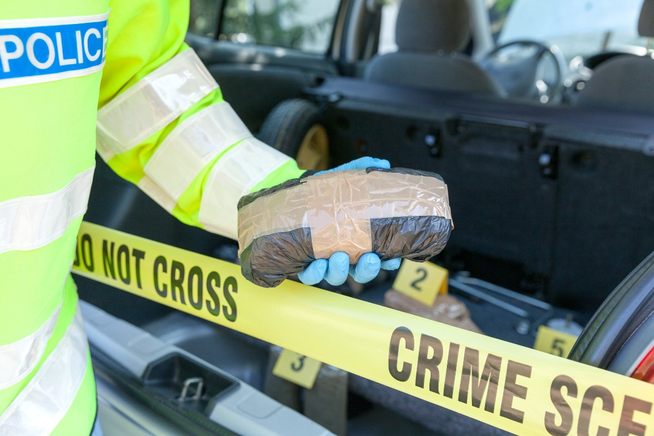 uk-police-with-packet-of-drugs